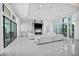 Bright, open living room with floor-to-ceiling windows, modern fireplace, and neutral decor at 9760 Solar Ave, Las Vegas, NV 89149