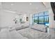 Bright living room boasts white sofas, plush rug, and large windows with a view to the pool at 9760 Solar Ave, Las Vegas, NV 89149