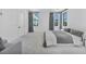 Bright main bedroom featuring carpeted floors, neutral walls, generous natural light, and minimalist design at 9760 Solar Ave, Las Vegas, NV 89149