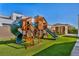 Backyard playground featuring slides, climbing ropes, and a swing set for outdoor fun and activity at 9760 Solar Ave, Las Vegas, NV 89149