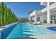 Luxurious pool area with cascading waterfall, lounge chairs, and lush landscaping for ultimate relaxation at 9760 Solar Ave, Las Vegas, NV 89149