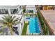 Aerial view of a modern backyard with pool, spa, turf, mature trees, and outdoor seating at 9760 Solar Ave, Las Vegas, NV 89149