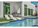 Backyard pool with in-water seating, outdoor kitchen, and sun loungers for ultimate relaxation at 9760 Solar Ave, Las Vegas, NV 89149