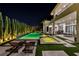 Resort-style backyard with rectangular pool, integrated spa, lounge chairs, and mature privacy landscaping at 9760 Solar Ave, Las Vegas, NV 89149