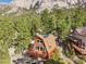 Aerial view of house featuring open deck with mature trees and mountain view at 2196 Via Dulcedo St, Mount Charleston, NV 89124