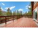 Expansive wood deck overlooking the treelined landscape with mountain view at 2196 Via Dulcedo St, Mount Charleston, NV 89124