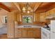 A-frame kitchen with wood cabinets and white appliances at 2196 Via Dulcedo St, Mount Charleston, NV 89124