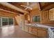 A cozy kitchen with wooden cabinets, countertops and natural lighting, perfect for cooking and entertaining at 2196 Via Dulcedo St, Mount Charleston, NV 89124