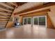 Cozy living room with a wood-burning stove, wood walls, and deck access at 2196 Via Dulcedo St, Mount Charleston, NV 89124