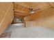 Loft area with carpeted floor, ceiling fan, wood-paneled walls and ceiling, and large windows offering natural light at 2196 Via Dulcedo St, Mount Charleston, NV 89124