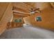 Cozy loft showcasing natural wood, carpeted floors, and a unique layout at 2196 Via Dulcedo St, Mount Charleston, NV 89124