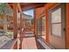 Side porch with wood railings and a sliding glass door to the home at 2196 Via Dulcedo St, Mount Charleston, NV 89124