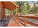 Long wood porch with wood railings and wooded scenery at 2196 Via Dulcedo St, Mount Charleston, NV 89124