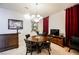 Cozy dining room featuring a round table, chandelier lighting, and elegant decorations on the wall at 2349 Villandry Ct, Henderson, NV 89074