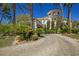 Attractive home with a circular driveway and lush landscaping, offering curb appeal at 2349 Villandry Ct, Henderson, NV 89074