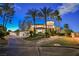 Elegant home featuring lush landscaping, circular driveway, and inviting entrance with palm trees at 2349 Villandry Ct, Henderson, NV 89074