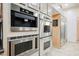 Modern kitchen featuring stainless steel appliances and custom cabinetry with a built-in coffee maker at 2349 Villandry Ct, Henderson, NV 89074