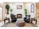 Inviting sitting area with a fireplace, two leather chairs, and a decorative rug offers a cozy space at 2349 Villandry Ct, Henderson, NV 89074