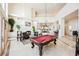Expansive living room with a fireplace, billiard table, and high ceilings and elegant finishes throughout at 2349 Villandry Ct, Henderson, NV 89074