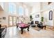 Open-concept living room with high ceilings, a fireplace, and a view of the pool at 2349 Villandry Ct, Henderson, NV 89074