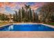 Beautiful pool with integrated spa and mature landscaping, creating a private backyard oasis at 2349 Villandry Ct, Henderson, NV 89074