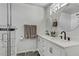 Modern bathroom featuring dual sinks, marble counters, and a glass-enclosed shower at 4474 Dawley Ct, Las Vegas, NV 89104