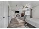 Bedroom featuring wood-look floors, a window, and a TV at 4474 Dawley Ct, Las Vegas, NV 89104