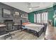 Comfortable bedroom features modern wood wall decor, wood-look floors, and a desk at 4474 Dawley Ct, Las Vegas, NV 89104
