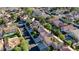 A bird's-eye view shows a neighborhood featuring homes with red tile roofs, solar panels, and verdant landscaping at 23 Antero Dr, Henderson, NV 89074