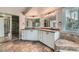 Bathroom featuring double sinks, granite counters, tile accents, and walk-in closet access at 23 Antero Dr, Henderson, NV 89074