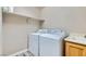 Laundry room equipped with washer, dryer, sink, and overhead shelving at 23 Antero Dr, Henderson, NV 89074