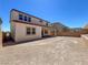 Exterior view of a two-story home with a covered patio and a large backyard at 9009 Shifting Skye St, Las Vegas, NV 89166