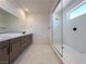Modern bathroom with sleek vanity, dual sinks, and a glass-enclosed walk-in shower at 9009 Shifting Skye St, Las Vegas, NV 89166