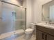 Bathroom featuring glass enclosed shower with white tile and seat, and vanity with white countertop at 9009 Shifting Skye St, Las Vegas, NV 89166