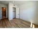 Bright bedroom features wood floors, closet and entry doors, and base trim at 9009 Shifting Skye St, Las Vegas, NV 89166
