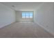 Spacious bonus room with carpet floors and a bright window at 9009 Shifting Skye St, Las Vegas, NV 89166