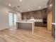 Stylish kitchen with a center island, dark cabinets, and stainless steel appliances at 9009 Shifting Skye St, Las Vegas, NV 89166