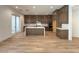 Gourmet kitchen featuring dark cabinets, an island, and stainless steel appliances at 9009 Shifting Skye St, Las Vegas, NV 89166