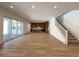 Expansive open-concept living space with wood floors and sliding glass doors at 9009 Shifting Skye St, Las Vegas, NV 89166