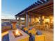 Outdoor seating area with fire pit and wooden pergola at 9009 Shifting Skye St, Las Vegas, NV 89166
