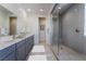 Virtually staged bathroom with double vanity and walk-in shower at 9068 Cielo Canyon St, Las Vegas, NV 89166