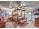 Luxurious main bedroom with a four-poster bed and private balcony at 8429 Brackenfield Ave, Las Vegas, NV 89178