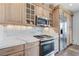 Modern kitchen featuring stainless steel appliances and light wood cabinets at 1150 Calcione Dr, Henderson, NV 89011