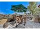 Patio seating area with umbrella and mountain views at 1150 Calcione Dr, Henderson, NV 89011