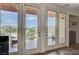 French doors open to a scenic view and relaxing patio area at 1150 Calcione Dr, Henderson, NV 89011