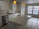 Modern kitchen with white cabinets and large island at 6449 Elizabethtown Ave, Las Vegas, NV 89110