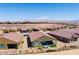 Wide aerial shot of the community featuring desert landscaping, tile roofs, and mountain views at 977 Majestic Vw, Mesquite, NV 89034