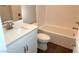 Modern bathroom with white vanity, bathtub, and tile flooring at 9886 Belikove Manor Ave, Las Vegas, NV 89178