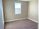 Well-lit bedroom featuring carpet and a window at 9886 Belikove Manor Ave, Las Vegas, NV 89178