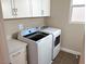 Laundry room with washer, dryer and white cabinets at 9886 Belikove Manor Ave, Las Vegas, NV 89178